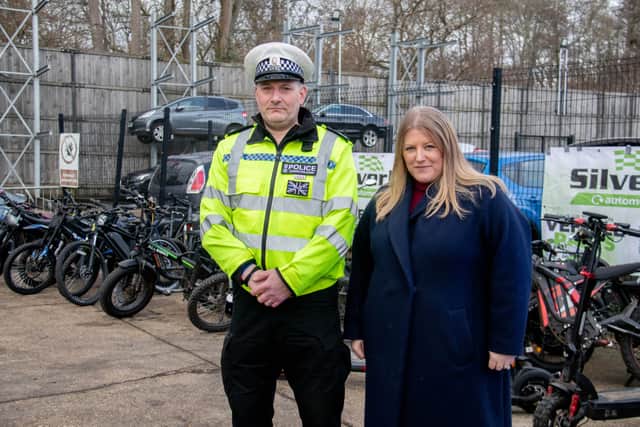 Road Safety Sergeant Jamie Dobson and Donna Jones near the seized motorcycles and scooters at Silverlake Garage