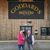 Andy Burdon, CEO of Powder Monkey, and Anthony Goddard, founder of Goddard's Brewery, toast the aquisition.