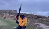 Video taken by the weather tracking group shows their team member battling against the strong winds while attempting to measure the wind speed. 