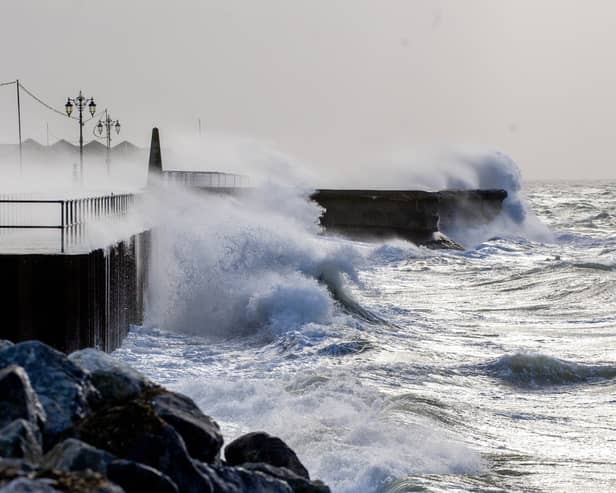 A flood alert has been issued for Hayling Island, with other warnings being issued across Hampshire. Pictured: Storm Eunice in Southsea.