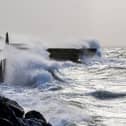 A flood alert has been issued for Hayling Island, with other warnings being issued across Hampshire. Pictured: Storm Eunice in Southsea.