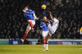 Freddie Potts jumps to challenge Millwall's Murray Wallace in Pompey's 1-0 defeat. Picture: Jason Brown/ProSportsImages