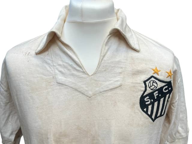 The football shirt worn by Pele when he scored his landmark 1,000th career goal is set to sell at auction for as much as £400,000. 