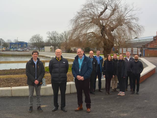Front centre: Cllr Leader and Forton Ward Councillor Peter Chegwyn, standing next to (left) Steve Fitzmaurice, Engineering Team Manager for Coastal Partners, and (right) Alister Butcher, Director of Estates and Safety at Lighthouse Learning Trust.

Back: Representatives from Coastal Partners, the construction team and the Environment Agency at the completed Forton defences.