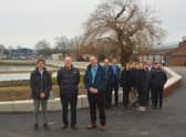 Front centre: Cllr Leader and Forton Ward Councillor Peter Chegwyn, standing next to (left) Steve Fitzmaurice, Engineering Team Manager for Coastal Partners, and (right) Alister Butcher, Director of Estates and Safety at Lighthouse Learning Trust.

Back: Representatives from Coastal Partners, the construction team and the Environment Agency at the completed Forton defences.