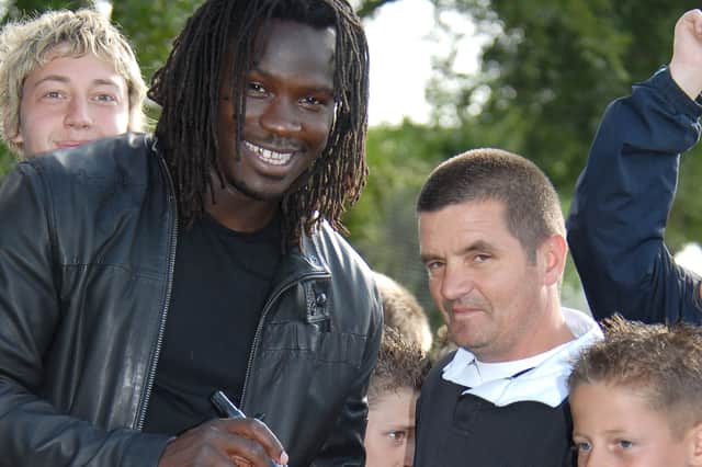 Bunny Reading meets then Pompey player Linvoy Primus at a community football event. Picture: Mick Young