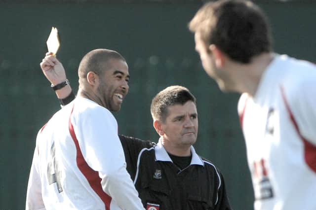 AFC GOP player Levi Foster is booked by Bunny Redding in 2009 after passing wind in the referee's face. Picture: Mick Young