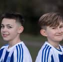 Flo Topham (L) and Camille Porhel, who play for York Railway Institute (YRI) AFC u12s Girls, have launched a campaign defending their right to have short hair, after they were accused of being boys during a game. 