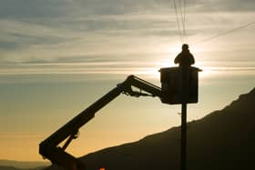 A BT worker fixs telephone lines (Photo: Ashley Cooper/Construction Photography/Avalon/Getty Images)