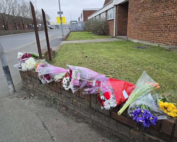 Flowers have been left at the scene where a woman in her 20s died after being hit a lorry yesterday morning.