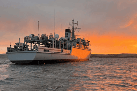 HMS Cattistock at anchor while conducting diving operations. The Royal Navy minehunter is due to replace HMS Middleton in Bahrain, Middle East.