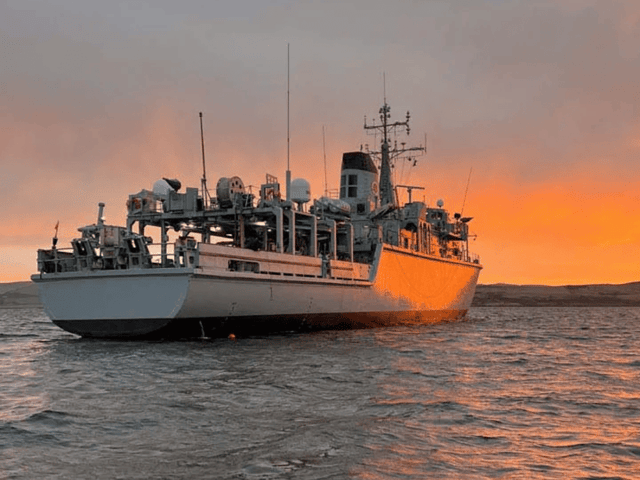 HMS Cattistock at anchor while conducting diving operations. The Royal Navy minehunter is due to replace HMS Middleton in Bahrain, Middle East.