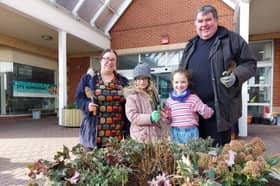 Councillor Kimberley Barrett and Reverend Canon Bob White help local children fill the new planters with shrubs outside The Bridge Centre in Fratton.