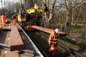 Giant pieces of Japanese-made artificial wood are craned into place, to sit beneath the new steel rails. It is part of major works on the upper railway lines at Portsmouth & Southsea station during February half-term
Picture: Chris Moorhouse (180225-25)