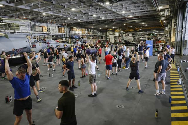 Here are all the details about the Royal Navy's Pre-Joining fitness test, and how you can beat it. Pictured are HMS Queen Elizabeth's ship's company take part in circuits in the hangar.