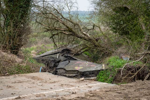 A road left so badly damaged by a landslip it was closed to cars can't be fixed properly - as it's still moving a YEAR later.