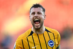 Brighton's former Pompey favourite, Adam Webster, celebrates captaining his side to victory over Southampton. Pic: Getty Images