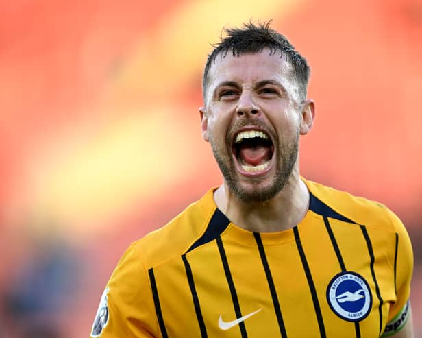 Brighton's former Pompey favourite, Adam Webster, celebrates captaining his side to victory over Southampton. Pic: Getty Images
