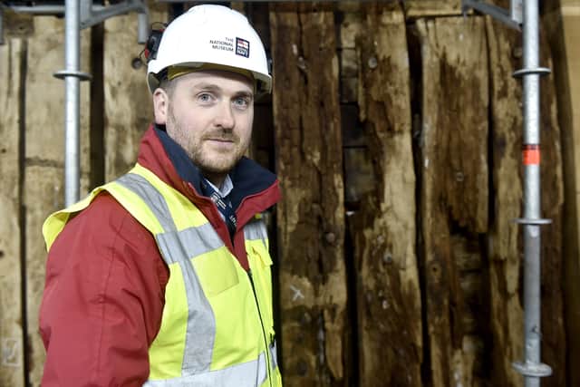 Pictured is: Simon Williams, project manager of HMS Victory The Big Repair, 37, of Southsea, next to one of the timber frames damaged on HMS Victory.