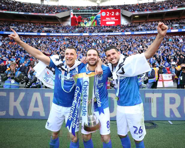 Lee Brown (left), Brett Pitman and Gareth Evans celebrate Pompey's Checkatrade Trophy triumph in March 2019 at Wembley. Picture: Joe Pepler