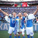Lee Brown (left), Brett Pitman and Gareth Evans celebrate Pompey's Checkatrade Trophy triumph in March 2019 at Wembley. Picture: Joe Pepler