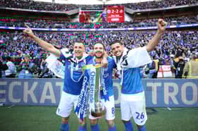 Lee Brown (left), Brett Pitman and Gareth Evans celebrate Pompey's Checkatrade Trophy triumph in March 2019 at Wembley. Picture: Joe Pepler