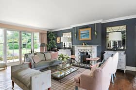 The listing says: "Built in the Georgian style in the 1960s, with more recent additions, the house is classically proportioned with light rooms, large sash windows and high ceilings." 