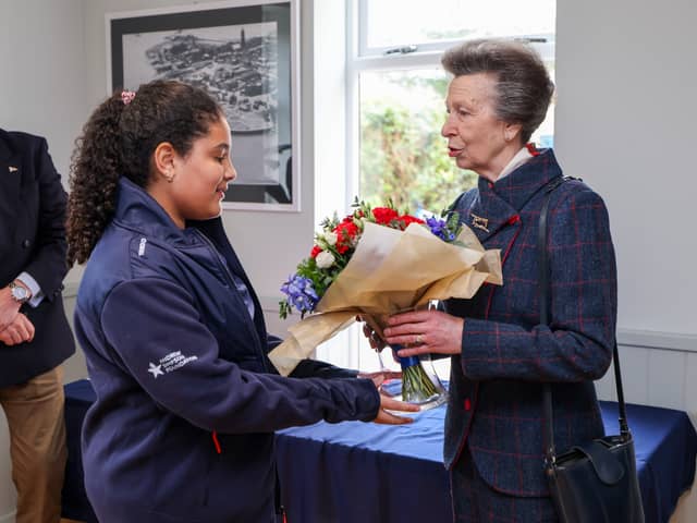 Pictured: HRH being presented with a posy of flowers by Miss Arrielle Deane, young crew member from the Royal Navy Sailing Association in Gosport.