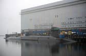 New Dreadnaught-class nuclear submarines are being built for the Royal Navy at a cost of £41bn, with a date being given as to when they'll enter the fleet. Pictured is a  Vanguard-class submarine undergoing maintenance at HM Naval Base Clyde at Faslane, north-west of Glasgow, Scotland.
