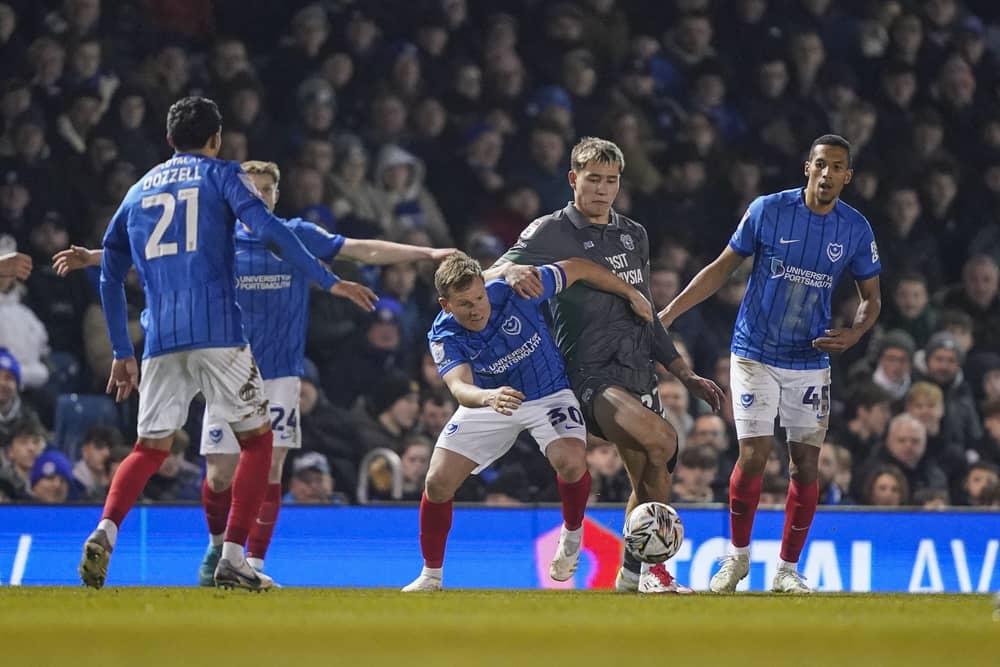 Pompey players press Cardiff's Ruben Colwill last month - but just how 'relentless' in their work compared to Championship rivals?