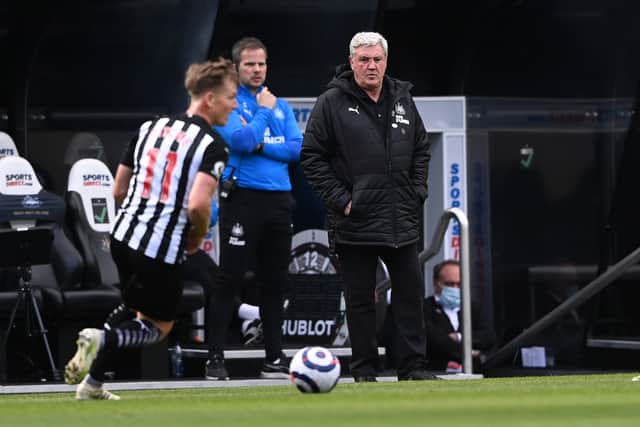 Matt Ritchie in action for Newcastle while Steve Bruce looks on in 2021