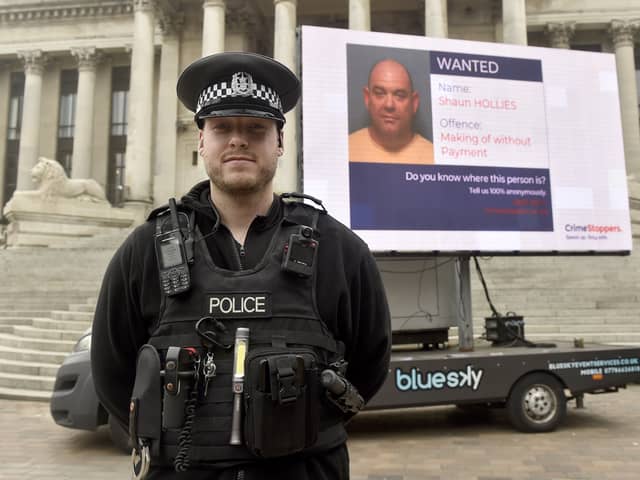 PC Jonathan Tallent with the digital advertising van in Guildhall Square, Portsmouth.