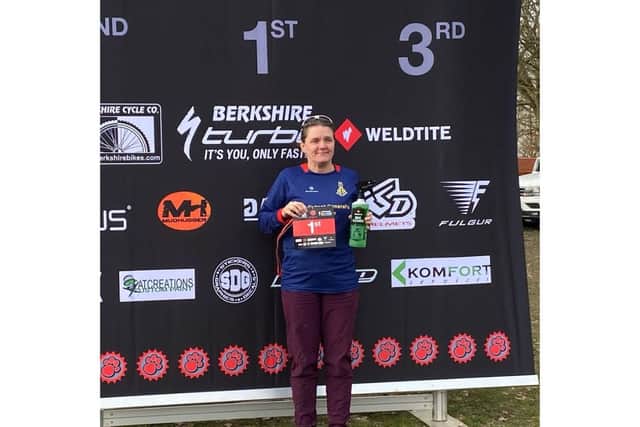 Dawn picking up first place in and enduro mountain biking race.