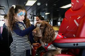 HMS Prince of Wales welcoming families and affiliates on board ahead of Indo-Pacific deployment. Pictured: Family of Lieutenant Smitham with a service dog.