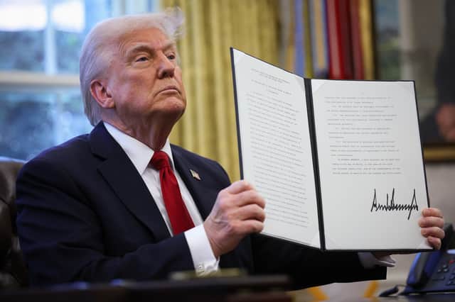 Donald Trump displays a signed, executive order to impose 25 per cent tariffs on all foreign-made cars. 