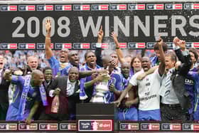Former Pompey defender Lucien Aubey, here to the left of Kanu in a suit, has been sent to prison for fraud. Pic: AFP via Getty Images