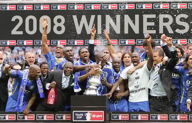 Former Pompey defender Lucien Aubey, here to the left of Kanu in a suit, has been sent to prison for fraud. Pic: AFP via Getty Images