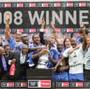 Former Pompey defender Lucien Aubey, here to the left of Kanu in a suit, has been sent to prison for fraud. Pic: AFP via Getty Images