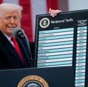 President Donald Trump holds up a chart of "reciprocal tariffs" while speaking during a trade announcement event in the Rose Garden at the White House.