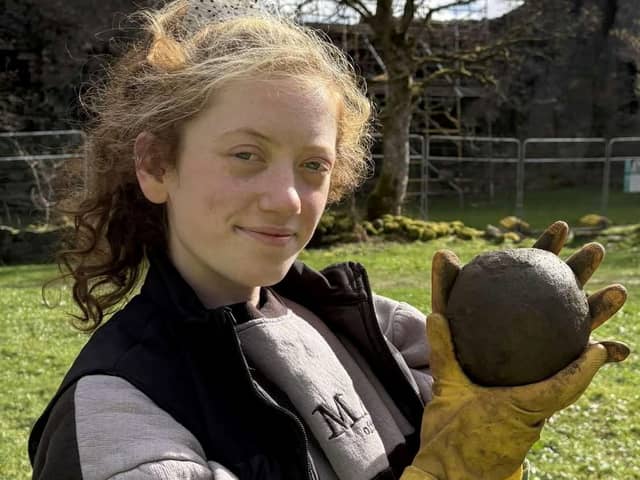 Magnet Fishing Edinburgh's Eryn and the 350-year-old cannonball found in the River Lochy in the Scottish Highlands. 