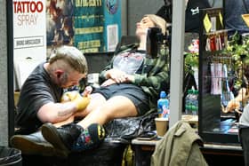 Tattoo artist at work. Picture: Nathan Lipsham