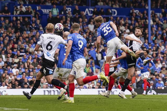 Rob Atkinson's stoppage-time header snatched a late point for Pompey.