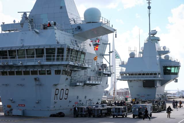 The Spinnaker tower sandwiched between HMS Prince of Wales' bridge and control tower.  Last minute preparations ahead of Operation Highmast.