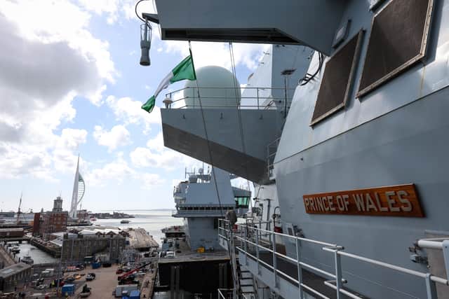 View down the side of HMS Prince of Wales, looking at the bridge, with the Spinnaker tower in the background.
