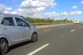 A police motorcycle spotted this driver taking a selfie while driving on the motorway.