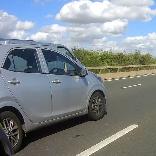A police motorcycle spotted this driver taking a selfie while driving on the motorway.