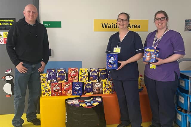 Pte Swindley alongside medical personnel at QA Hospital after donating the Easter Eggs.