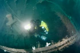 Dom Robinson, beside the shipwreck.