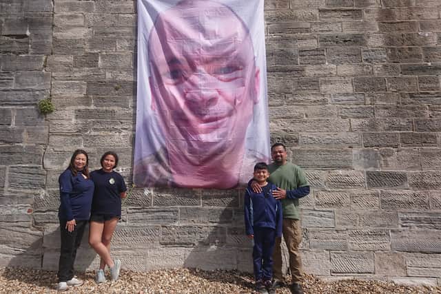 David and Priscilla Herrera, originally from Texas, with a large mural of Jim Witton - NAS Dambusters - as a prank for those on board HMS Prince of Wales