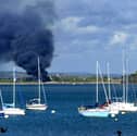 Thick plume of smoke visible across the water from Gosport